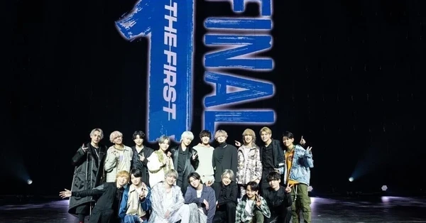 BMSG group photo on stage with "THE FIRST FINAL" backdrop.