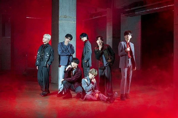 BMSG members pose stylishly in a red - lit space for "THE FIRST FINAL".