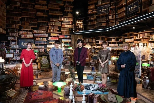 A group photo of five people standing in a bookstore